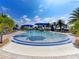Resort-style pool with blue umbrellas and lounge chairs at 19374 Rizzuto St, Venice, FL 34293