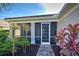 Enclosed porch with brick pavers and tropical plants at 19374 Rizzuto St, Venice, FL 34293