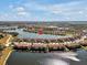 Aerial view of community, lake, and property location at 23108 Banbury Way # 202, Venice, FL 34293