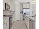 Modern kitchen with stainless steel appliances and white cabinets at 23108 Banbury Way # 202, Venice, FL 34293