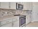 Modern kitchen with stainless steel appliances and white cabinets at 23108 Banbury Way # 202, Venice, FL 34293