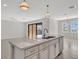 Open concept kitchen with island and balcony view at 23108 Banbury Way # 202, Venice, FL 34293