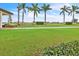 Landscaped lawn with palm trees at 23108 Banbury Way # 202, Venice, FL 34293