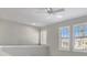 Bright loft area with three windows and ceiling fan at 23108 Banbury Way # 202, Venice, FL 34293