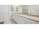 Double vanity bathroom with modern fixtures and a large mirror at 23471 Awabuki Dr, Venice, FL 34293