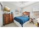Cozy bedroom featuring a vintage dresser and comfortable bedding at 23471 Awabuki Dr, Venice, FL 34293
