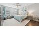 Spacious bedroom with light blue bedding and large windows at 23471 Awabuki Dr, Venice, FL 34293