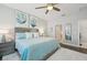 Main bedroom with light blue bedding and wood flooring at 23471 Awabuki Dr, Venice, FL 34293