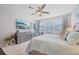 Bright bedroom featuring a plush bed and a large TV at 23471 Awabuki Dr, Venice, FL 34293