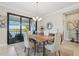 Elegant dining room with a wooden table and lake view at 23471 Awabuki Dr, Venice, FL 34293