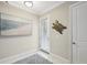 Light and airy entryway with coastal decor and door to garage at 23471 Awabuki Dr, Venice, FL 34293