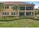Back exterior showcasing a two-story home with screened patio at 23471 Awabuki Dr, Venice, FL 34293