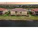 Back exterior of home showcasing lakefront view at 23471 Awabuki Dr, Venice, FL 34293