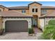 Two-story townhome with attached garage and landscaping at 23471 Awabuki Dr, Venice, FL 34293