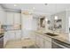 Modern kitchen with white cabinets, granite countertops, and stainless steel appliances at 23471 Awabuki Dr, Venice, FL 34293