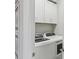 Convenient laundry room with white cabinets and modern washer/dryer at 23471 Awabuki Dr, Venice, FL 34293