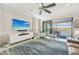 Bright living room with water view, features a large TV and comfy seating at 23471 Awabuki Dr, Venice, FL 34293