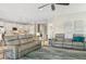 Spacious living area with gray couches and open floor plan at 23471 Awabuki Dr, Venice, FL 34293