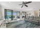 Spacious living area showcasing a large sectional sofa and access to a balcony overlooking a lake at 23471 Awabuki Dr, Venice, FL 34293