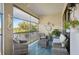 Relaxing screened balcony overlooking a lake with outdoor furniture at 23471 Awabuki Dr, Venice, FL 34293