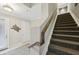 Modern staircase leading to upper level from entryway at 23471 Awabuki Dr, Venice, FL 34293