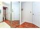 Bathroom with a large mirror and terracotta tile floors at 237 Southampton Ln # 275, Venice, FL 34293
