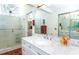 Bathroom with a marble vanity, double sinks, and large mirror at 237 Southampton Ln # 275, Venice, FL 34293
