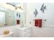 Clean bathroom with white vanity, marble countertop, and decorative accents at 237 Southampton Ln # 275, Venice, FL 34293