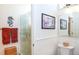 Bathroom with shower, white tile, and framed artwork at 237 Southampton Ln # 275, Venice, FL 34293