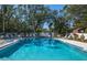 Inviting community pool with lounge chairs and lush landscaping at 237 Southampton Ln # 275, Venice, FL 34293