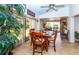 Bright dining area with wood table and chairs, view to backyard at 237 Southampton Ln # 275, Venice, FL 34293