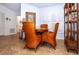 Bright dining area with a wooden table and wicker chairs near a hallway and bathroom at 237 Southampton Ln # 275, Venice, FL 34293