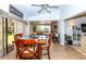 Bright dining area with wood table and chairs, view to backyard at 237 Southampton Ln # 275, Venice, FL 34293