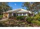 Single story home with a yellow exterior and landscaping at 237 Southampton Ln # 275, Venice, FL 34293