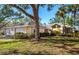 A charming single-story home with a three-car garage, mature landscaping, and a lush lawn at 237 Southampton Ln # 275, Venice, FL 34293