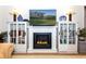 Modern fireplace with built-in shelving and cabinets on either side at 237 Southampton Ln # 275, Venice, FL 34293