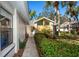 A walkway leads to the front entrance, surrounded by well-maintained landscaping and palm trees at 237 Southampton Ln # 275, Venice, FL 34293