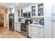 Modern kitchen featuring white cabinets, stainless steel appliances, and ample counter space at 237 Southampton Ln # 275, Venice, FL 34293