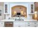 Kitchen features white cabinets, stainless steel appliances, and a double sink at 237 Southampton Ln # 275, Venice, FL 34293