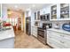 Updated kitchen with stainless steel appliances and white cabinetry at 237 Southampton Ln # 275, Venice, FL 34293