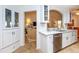 Modern kitchen features white shaker cabinets, quartz countertops, and a view to the living room at 237 Southampton Ln # 275, Venice, FL 34293