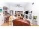 Spacious living room with a sectional sofa, fireplace, and access to kitchen at 237 Southampton Ln # 275, Venice, FL 34293