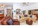 Open and airy living room with comfortable seating, a view of the kitchen, and high ceilings at 237 Southampton Ln # 275, Venice, FL 34293
