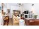Open living area features a sectional sofa, fireplace, and kitchen bar at 237 Southampton Ln # 275, Venice, FL 34293