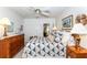 Main bedroom with a double bed, dresser, and window access at 237 Southampton Ln # 275, Venice, FL 34293