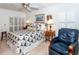 Main bedroom with double bed, chair, and window shutters at 237 Southampton Ln # 275, Venice, FL 34293