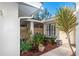 A charming, private patio area with lush tropical plants and decorative pots at 237 Southampton Ln # 275, Venice, FL 34293