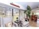Cozy sitting area with two armchairs and side table, overlooking the backyard at 237 Southampton Ln # 275, Venice, FL 34293