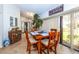 Sunroom boasts a wooden table with seating, a view to the backyard, and cabinet storage at 237 Southampton Ln # 275, Venice, FL 34293