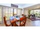 Sunroom with wooden dining table and chairs, offering a view of the backyard at 237 Southampton Ln # 275, Venice, FL 34293